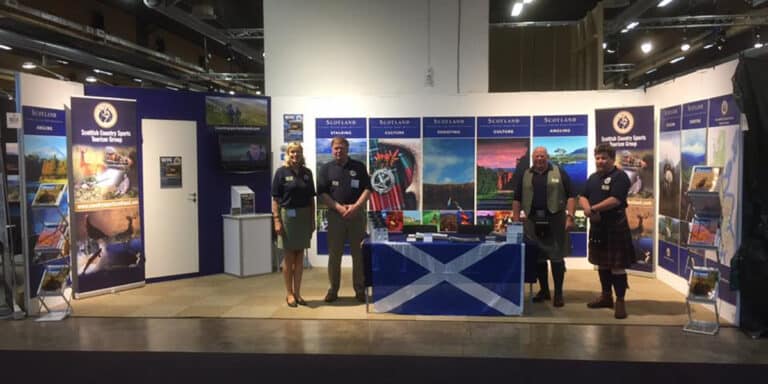 group of people on a trade fair stand