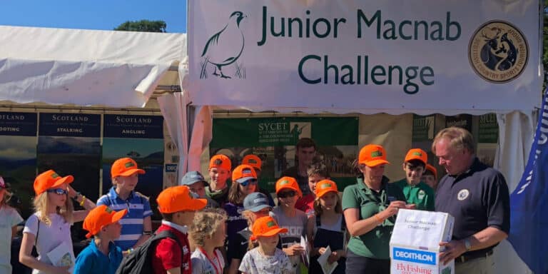 group of children in front of Junior Macnab Challenge tent
