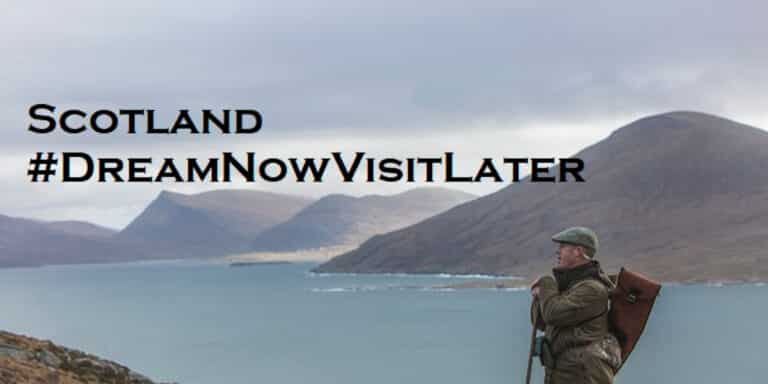 man spying for deer with coast and hills in background