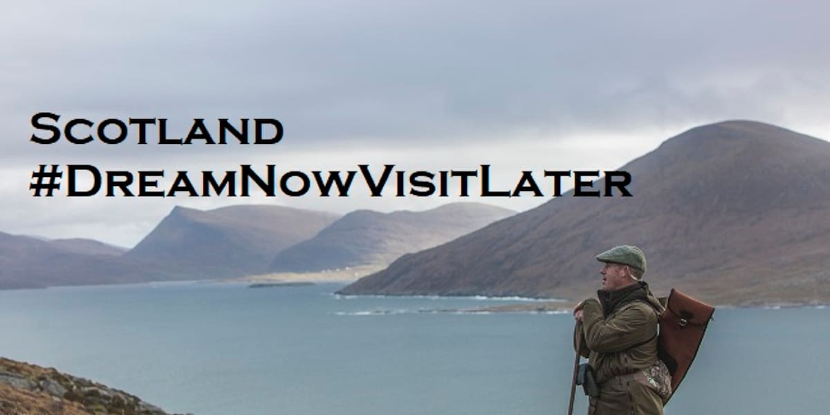 man spying for deer with coast and hills in background