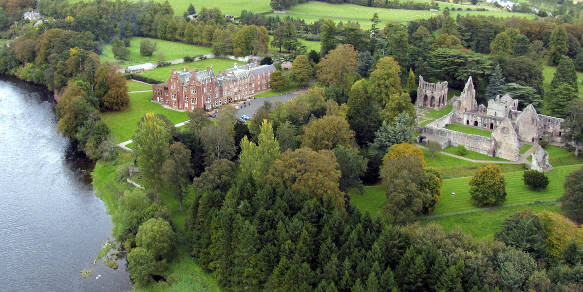 aerial photograph on red sandstone hotel and ruined abbey by River Tweed