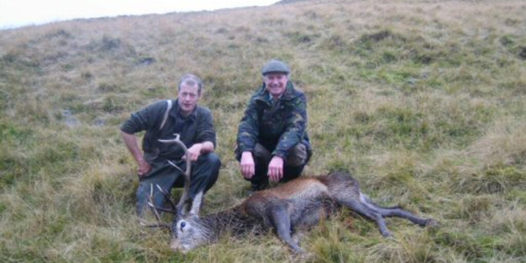 Invercauld_estate_2_stalkers_with_red_deer_stag_Scottish_Hill