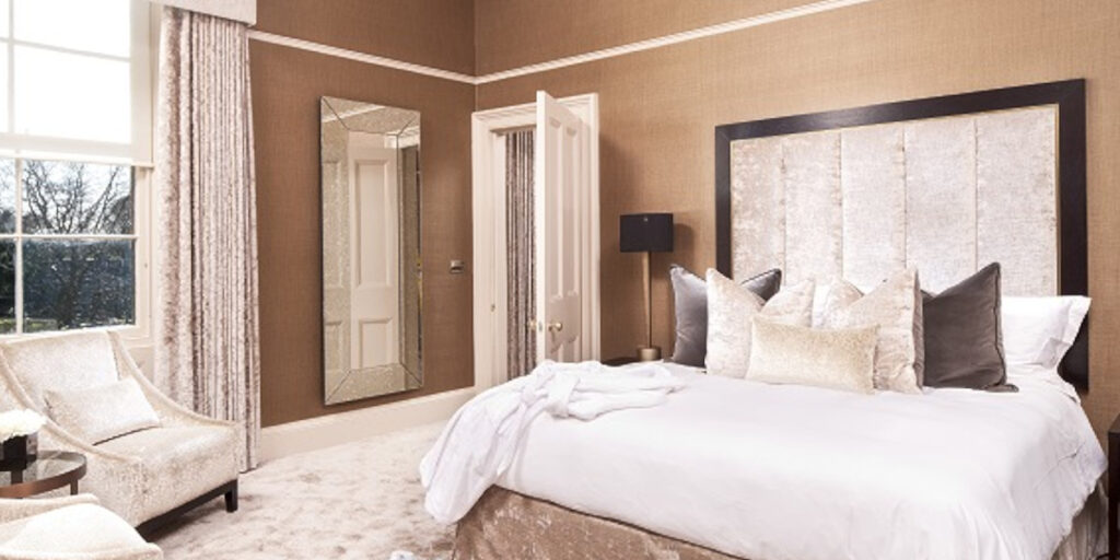 hotel bedroom with double bed beige