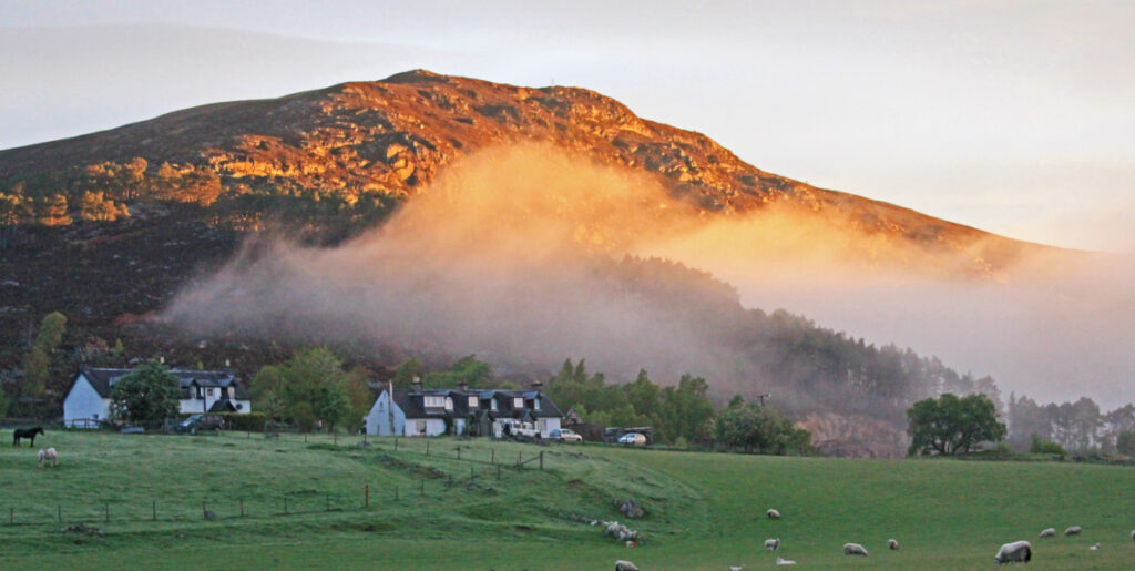 Scottish cottages set on sunlit hillside