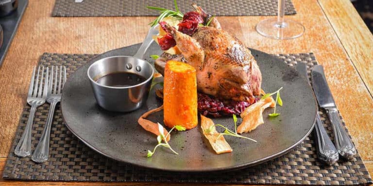 plate of roast grouse and vegetables