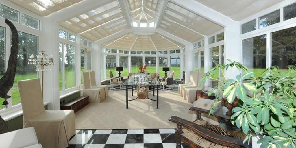 very large conservatory with black and white floor tiles