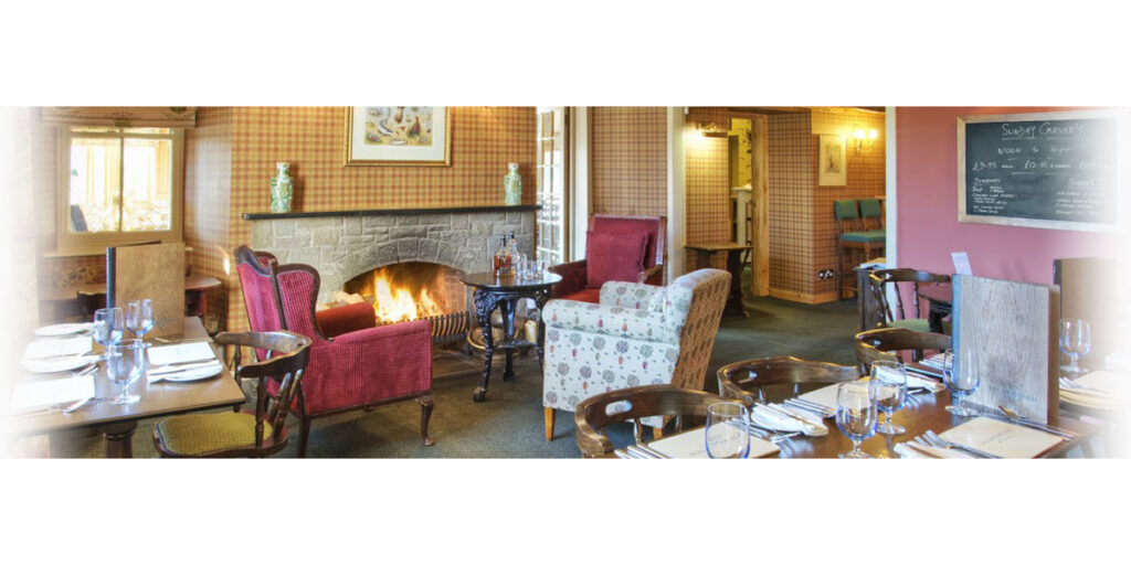 hotel dining room with lit open fire