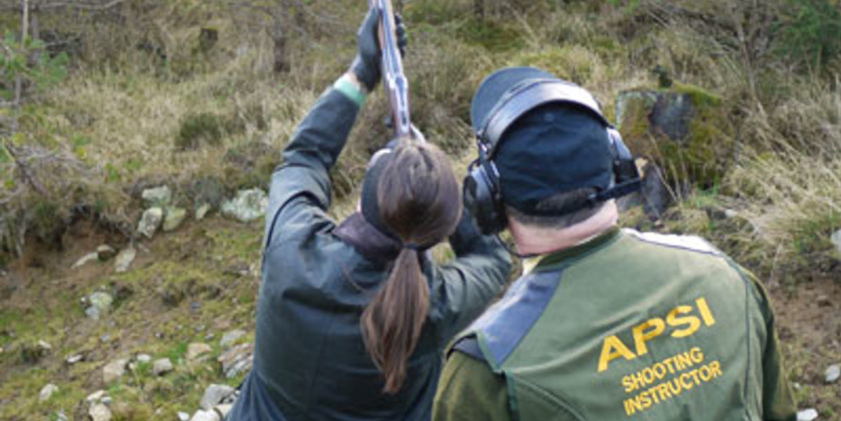 lady clay pigeon shooter receiving instruction