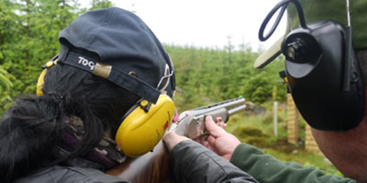 clay pigeon shooter with yellow ear defenders