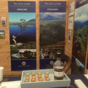 tray of glasses with bottle of bruadar on game fair stand