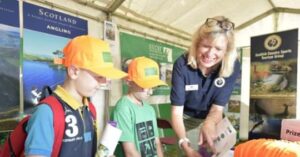 louise with children in SCSTG tent